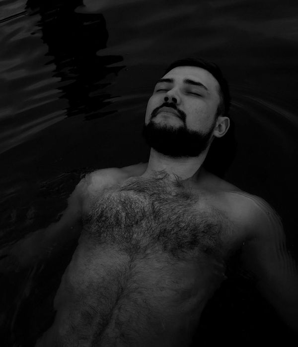 Woman with closed eyes meditating peacefully in a calm environment.